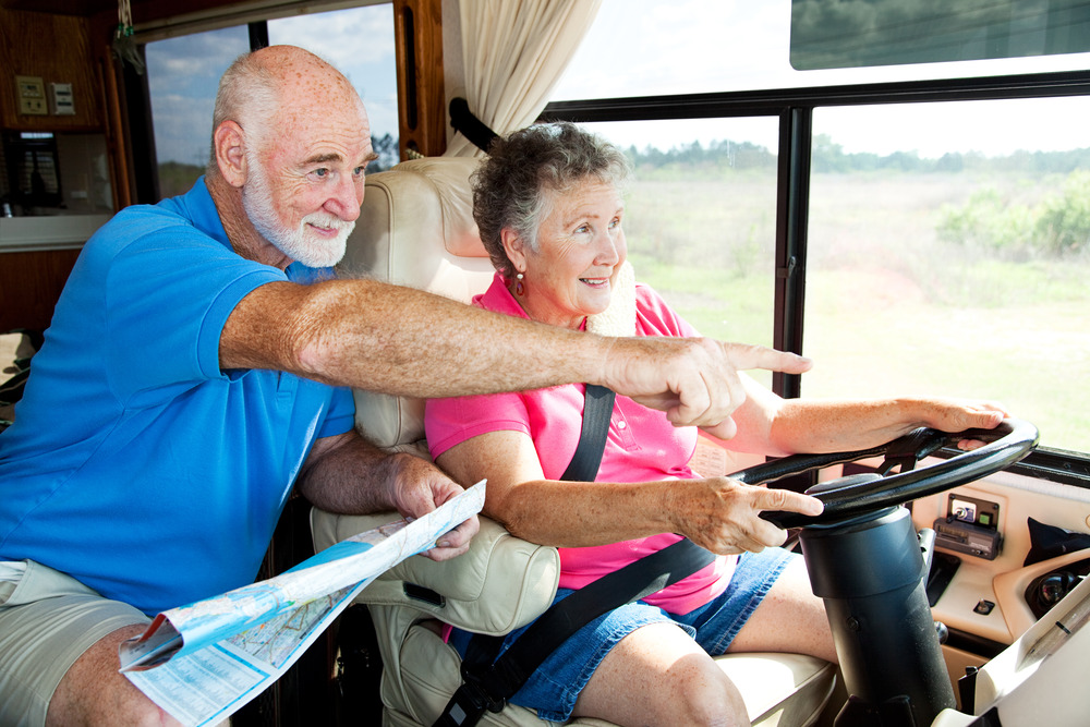 woman driving an rv while someone else points the way