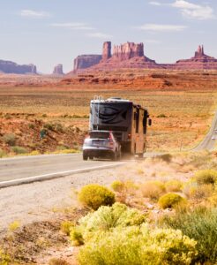 RV driving through Monument Valley on the road